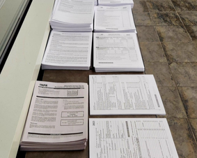 Photo of tax forms on a table inside Menomonee Falls Public Library.